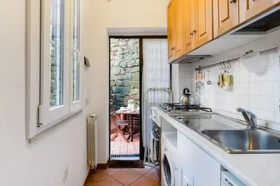 a kitchen with a sink and a counter top at Trastevere Cottage in Rome