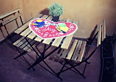 a wooden picnic table with a peace sign on it at Roma Sweet Dreams casa vacanze in Rome