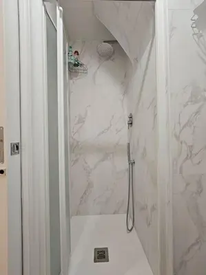 a white bathroom with a shower and a toilet at Roma Sweet Dreams casa vacanze in Rome