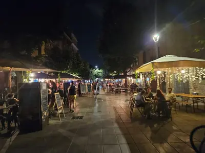a group of people sitting at tables at night at Roma Sweet Dreams casa vacanze in Rome