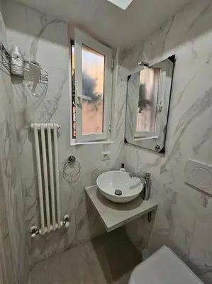 a bathroom with a sink and a toilet and a mirror at Roma Sweet Dreams casa vacanze in Rome