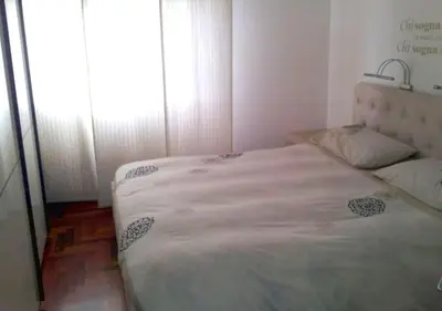 a bedroom with a large bed with a window at La casa Bomboniera in Rome
