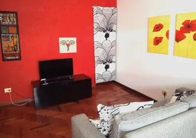 a living room with a couch and a flat screen tv at La casa Bomboniera in Rome