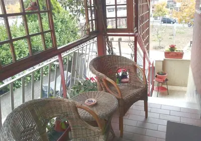a balcony with two chairs and a table at La casa Bomboniera in Rome