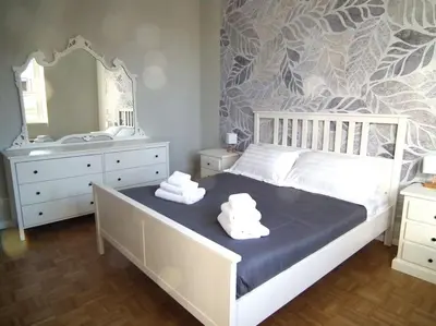 a bedroom with a bed and a sink and a mirror at WelcRome Appartamento Roma Centro in Rome