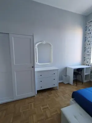 a bedroom with a white dresser and a mirror at WelcRome Appartamento Roma Centro in Rome