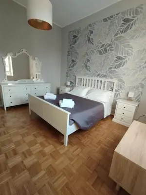 a bedroom with a bed and a dresser and a mirror at WelcRome Appartamento Roma Centro in Rome