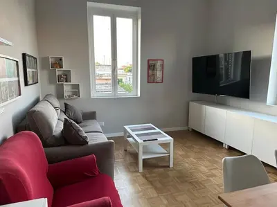 a living room with a couch and a flat screen tv at WelcRome Appartamento Roma Centro in Rome