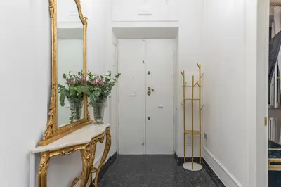 a hallway with a mirror and a console with flowers on it at Vista su Campo de Fiori in Rome