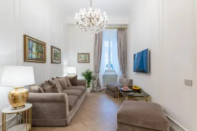 a living room with a couch and a chandelier at Vista su Campo de Fiori in Rome