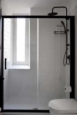 a bathroom with a shower with a toilet and a window at RoMa Apt In Vatican in Rome