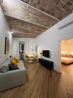 a living room with a couch and a bedroom at Civico26 in Rome