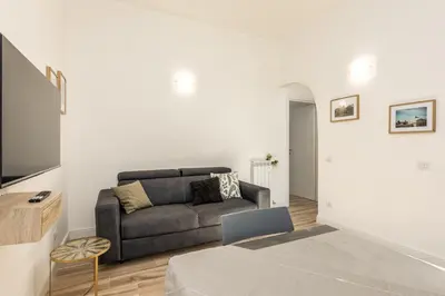 a living room with a couch and a table at Casa di Azzurra in Rome