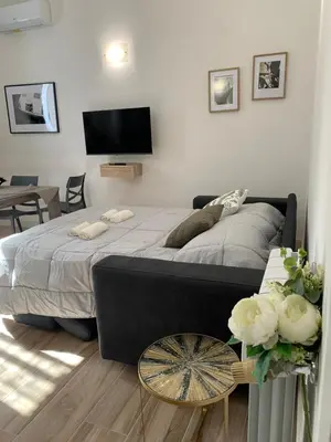 a bedroom with a large bed and a table at Casa di Azzurra in Rome