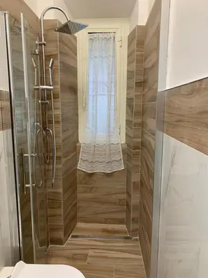 a bathroom with a shower and a toilet at Casa di Azzurra in Rome