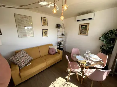 a living room with a couch and a table at Trastevere Penthouse in Rome
