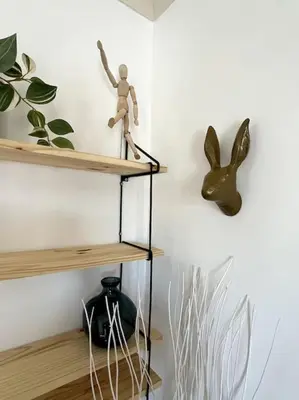 a shelf with a figurine on it in a room at Trastevere Penthouse in Rome