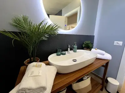 a bathroom with a sink and a potted plant at Trastevere Penthouse in Rome