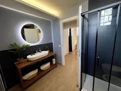 a bathroom with a sink and a mirror at Trastevere Penthouse in Rome