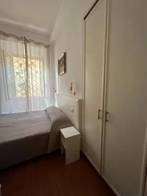a bedroom with a bed and a sliding door at Don sweet home- Hedi 101 in Rome