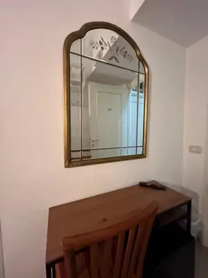 a mirror on a wall with a wooden table at Don sweet home- Hedi 101 in Rome