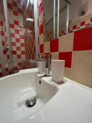 a bathroom with a white sink with a faucet at Don sweet home-Hedi in Rome