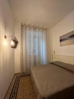 a small bedroom with a bed and a window at Don sweet home-Hedi in Rome