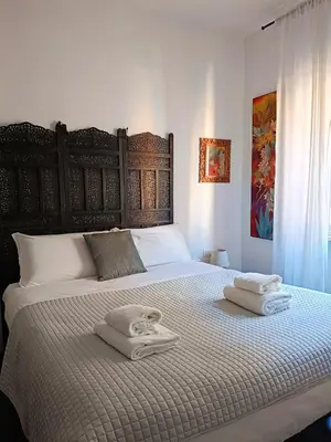 a bedroom with a large bed with towels on it at Un angolo di Oriente a due passi da San Pietro in Rome