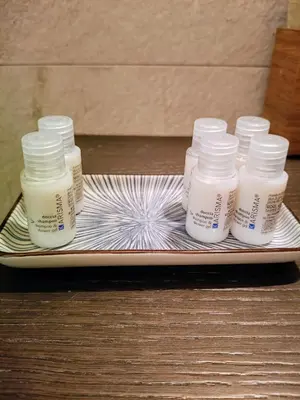 four bottles of moisturizers on a plate on a table at Un angolo di Oriente a due passi da San Pietro in Rome