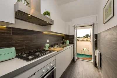 a kitchen with a stove and a sink at Elegante appartamento 130mq in stile classico in Rome