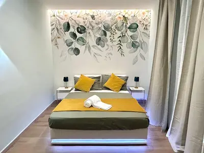 a bed in a room with a painting on the wall at The Rooms of Wonders in Rome