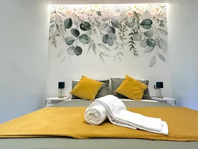 a bedroom with a bed with a flower mural on the wall at The Rooms of Wonders in Rome
