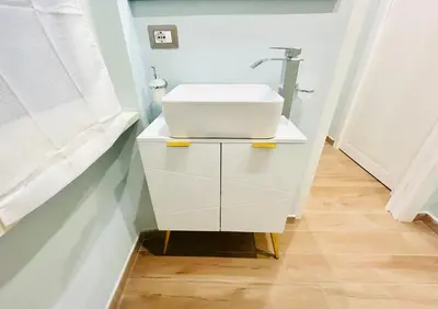 a white bathroom with a sink and a mirror at The Rooms of Wonders in Rome