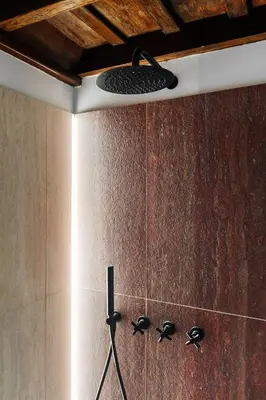 a shower in a bathroom with a shower head at Domus Minelli Navona by GHOR in Rome