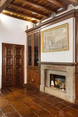 a living room with a fireplace and a painting on the wall at Domus Minelli Navona by GHOR in Rome