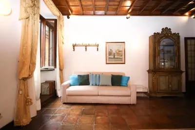 a living room with a couch and a cabinet at Domus Minelli Navona by GHOR in Rome
