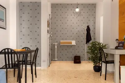 a dining room with a table and a wall at Cozy Retreat Saint John in Rome