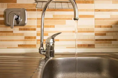 a kitchen sink with water coming from a faucet at Cozy Retreat Saint John in Rome