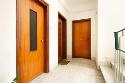 a hallway with two brown doors and a tile floor at Cozy Retreat Saint John in Rome