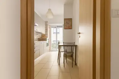 a kitchen with a table and a dining room at Cozy Retreat Saint John in Rome
