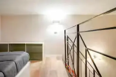 a living room with a couch and a glass railing at Charme Holidays Trastevere in Rome