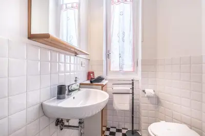a white bathroom with a sink and a toilet at Galaxia Home in Rome