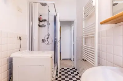 a white bathroom with a sink and a shower at Galaxia Home in Rome