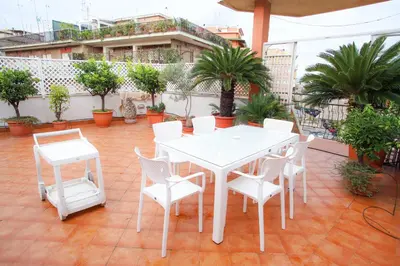 a white table and chairs on a patio at Oasi urbana - The Vatican Roof Garden in Rome