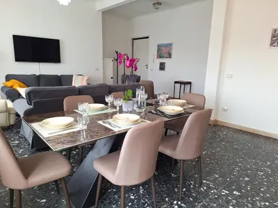 a dining room with a table and chairs and a couch at Oasi urbana - The Vatican Roof Garden in Rome