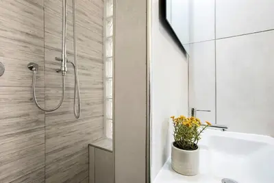 a bathroom with a shower and a white sink at Urban Oasis near Termini with Patio, int1b in Rome