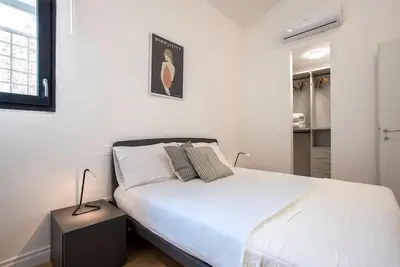 a white bedroom with a bed and a window at Urban Oasis near Termini with Patio, int1b in Rome