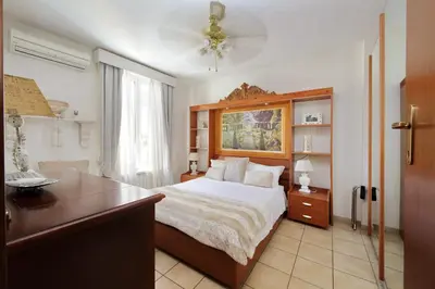 a bedroom with a large bed with a desk and a dresser at Luxury Navona apartments by Flatinrome in Rome