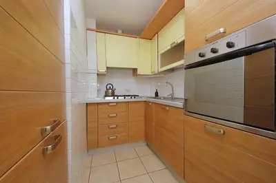 a kitchen with wooden cabinets and a stove top oven at Luxury Navona apartments by Flatinrome in Rome