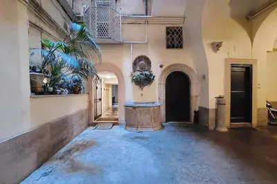 a hallway of a building with a plant at Luxury Navona apartments by Flatinrome in Rome